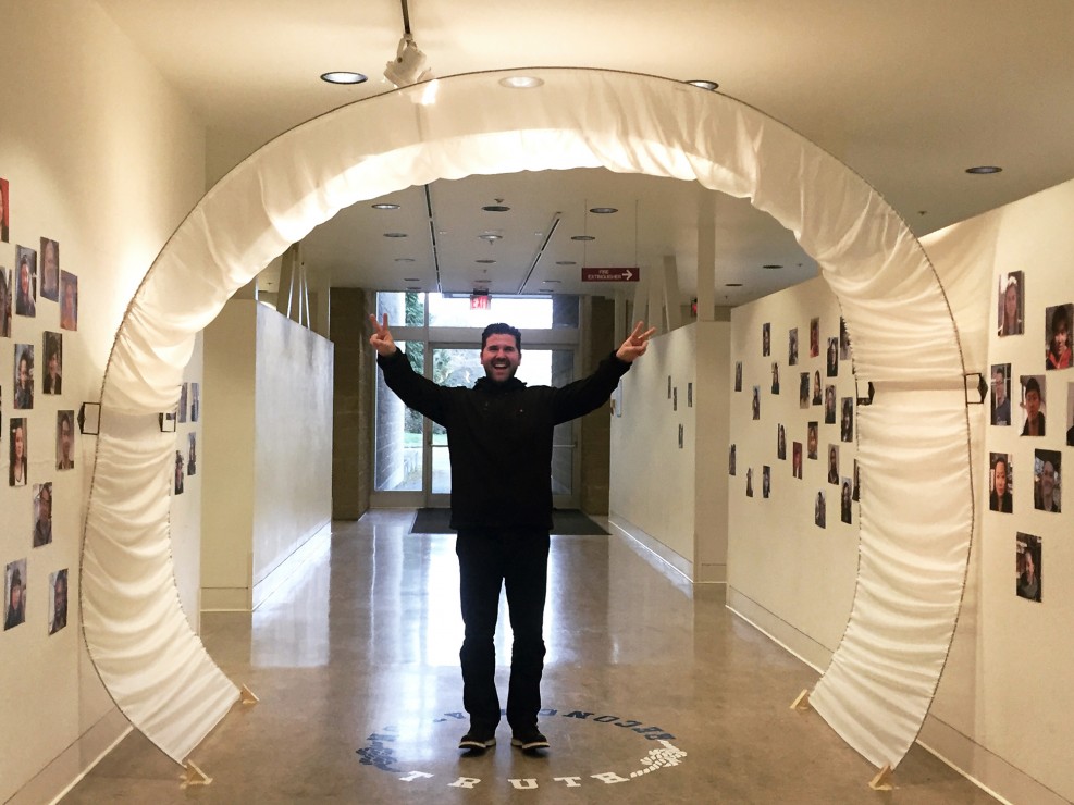 Rande Cook, pictured during his class, showing off an art installation dedicated to the Truth and Reconciliation Act. Photo provided