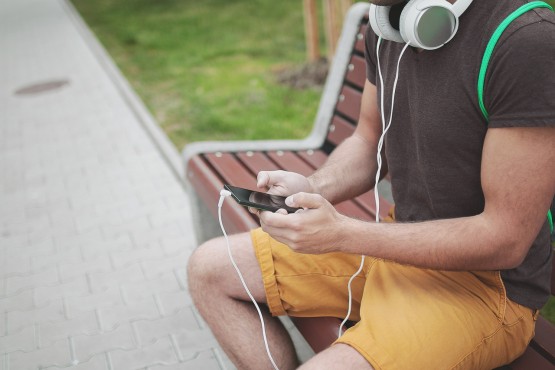 "Hmm, what should I listen to?" We got you covered, anonymous stock photo model. Stock image via pexels.com