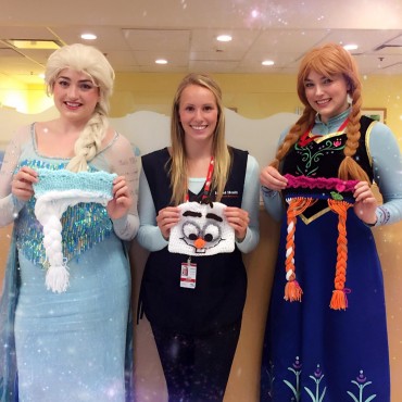 UVic Vikes swimmer, Taylor Snowden-Richardson (centre), poses with her themed hats alongside two staff members dressed as Anna and Elsa, the main characters from Disney's Frozen. Photo via Instagram