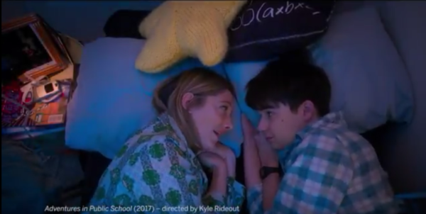 A mother and son lay next to each other talking in the trailer for the film Adventures in Public School