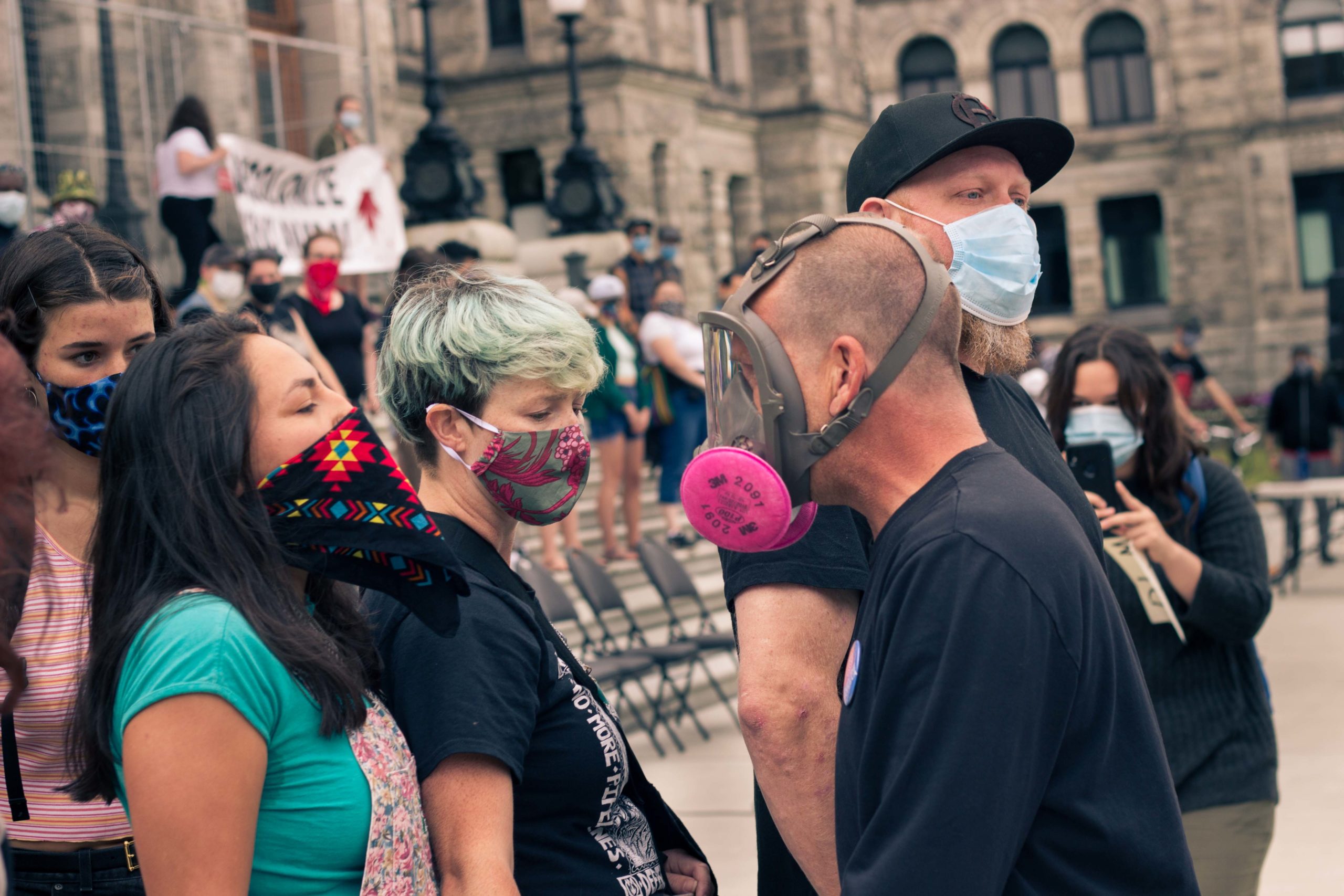 a far right protestor intimidates a Resist Canada 153 organizer