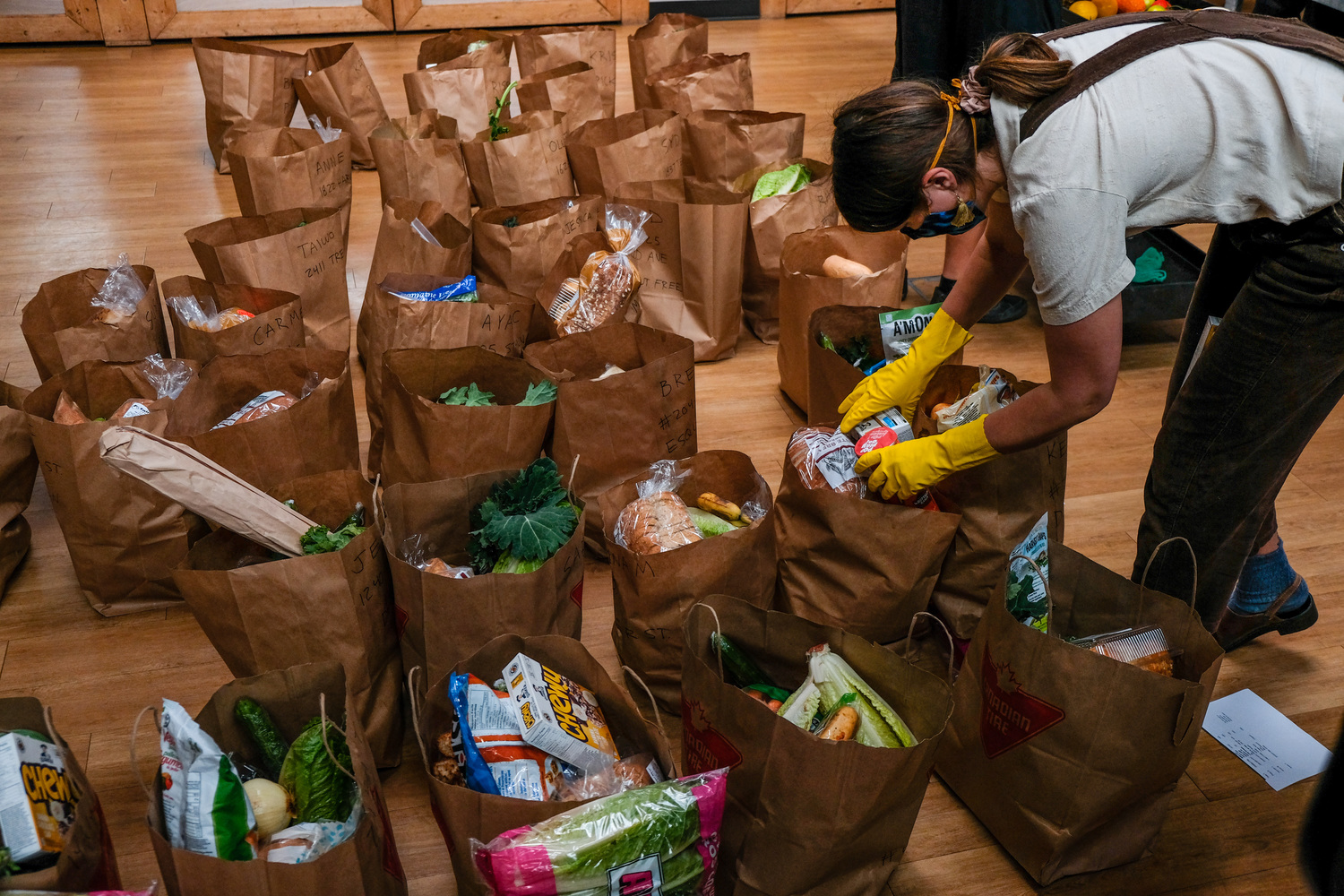 volunteer packs hampers at Community Food Support