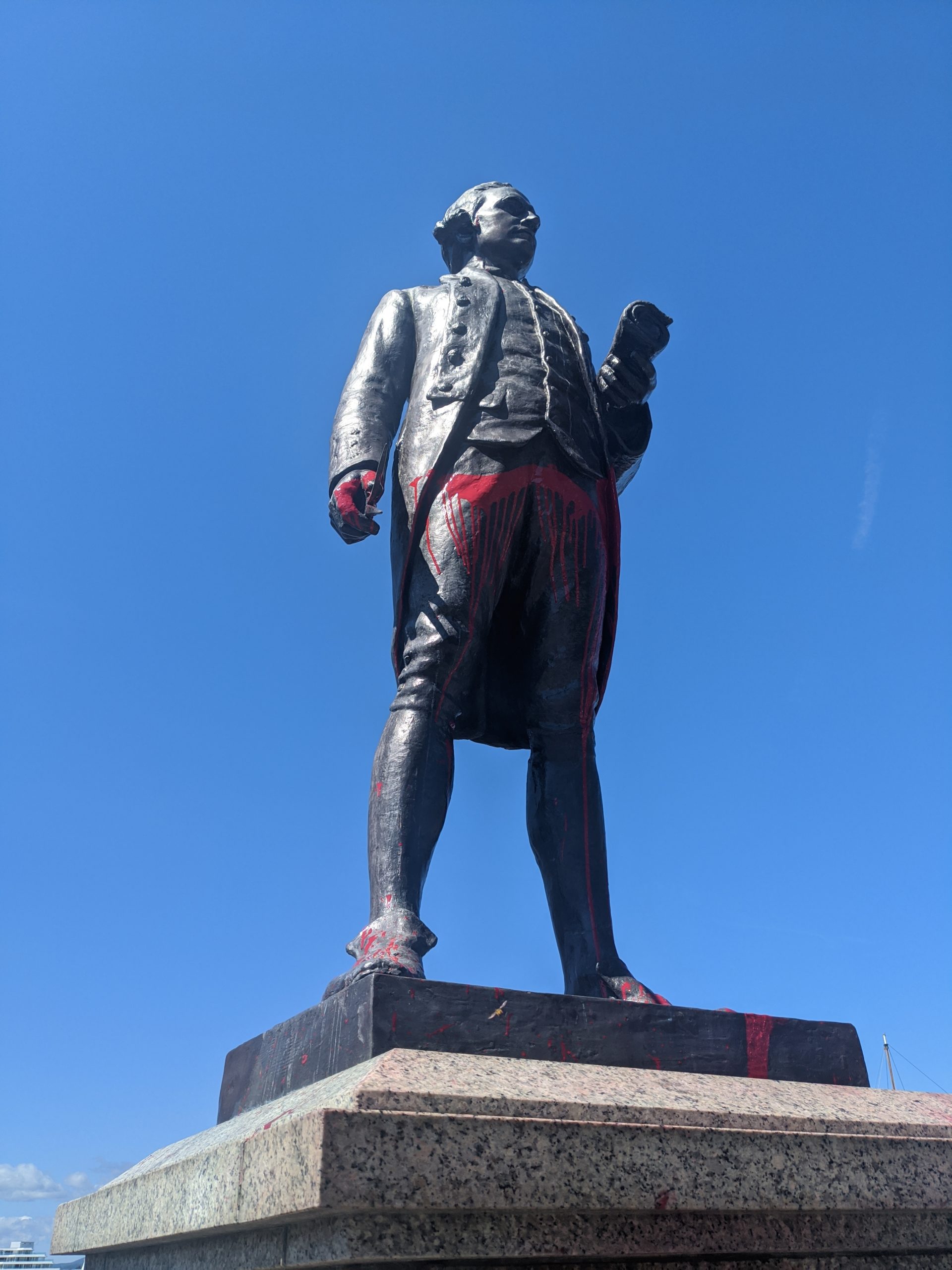 Statue of James Cook with red paint