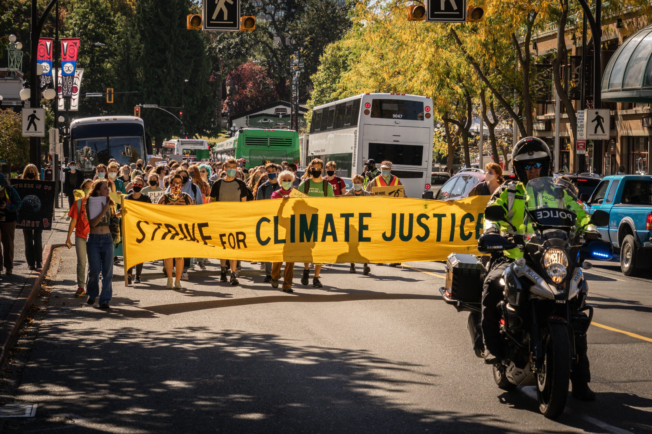 A climate strike banner reading "strike for climate justice".