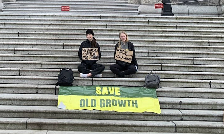 Grace Charness and Jordana Pangburn holding hunger strike sign at the B.C. Parliament, photo provided by Tim Brazier.