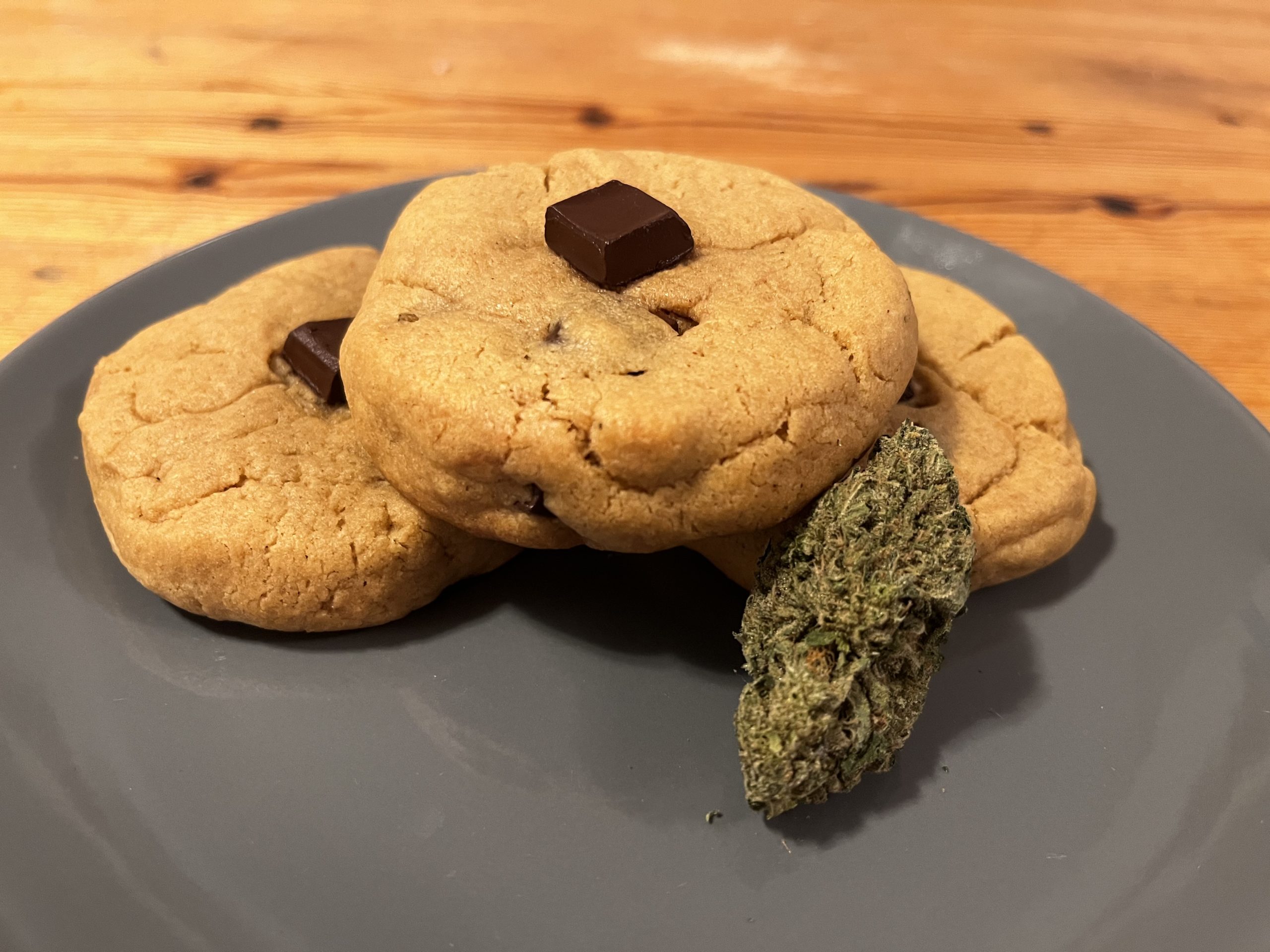 Peanut butter cookies with a cannabis flower and chocolate on top, photo by Atum Beckett.
