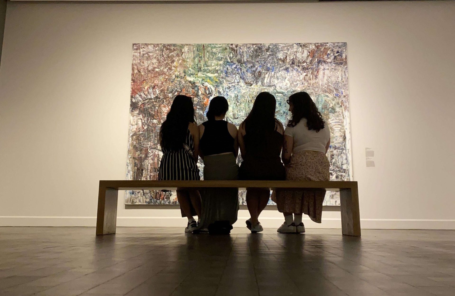 Four people at an art gallery. Photo by Angie Lu.