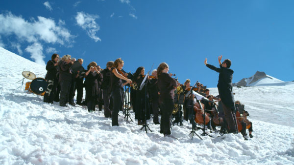 Paul Walde conducts a performance of "Requiem for a Glacier" on a glacier. Photo by Douglas Noblet.