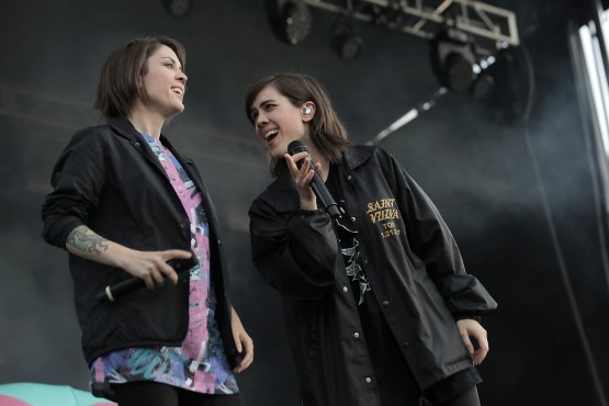Sisters Tegan, right, and Sara Quin share a moment on stage at Victoria's Canada 150 celebrations.