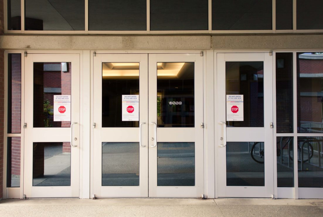 David Strong Building with COVID-19 notices on the doors
