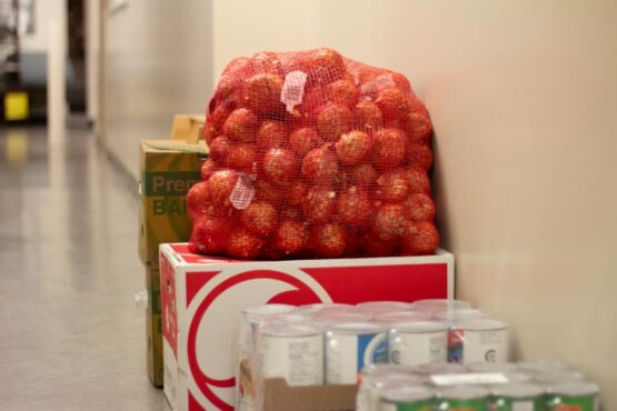 Crates of food stacked in a hallway