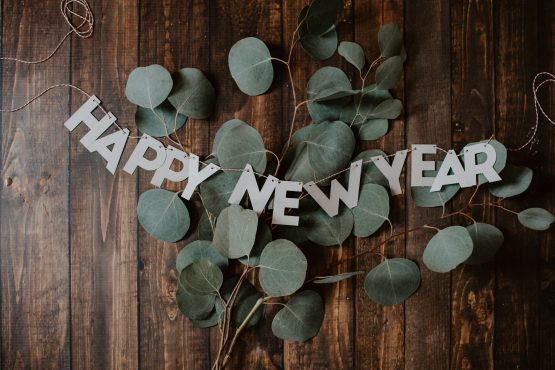 A Happy New Years sign, photo by Kelly Sikkema via Unsplash.